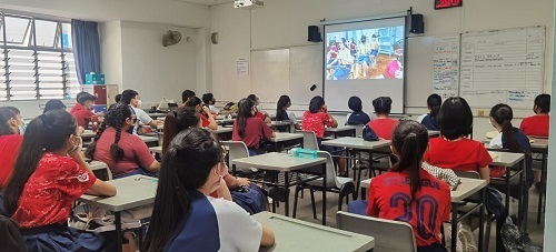 Students watching live streaming of pre-recorded Chinese Orchestra Performance at their classroom